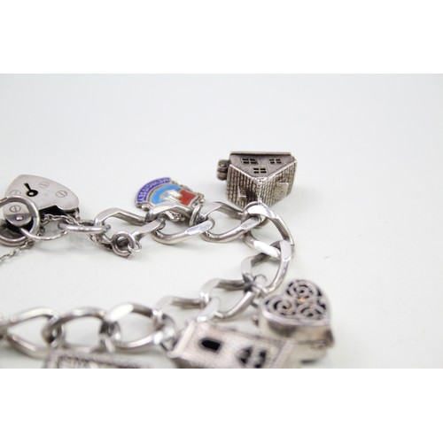 432 - Silver charm bracelet with opening charms (68g)