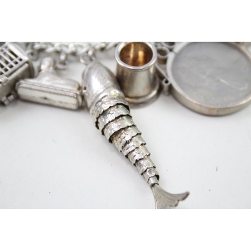 434 - Silver charm bracelet including articulated fish charm (115g)