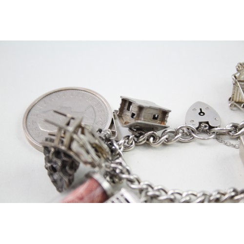 434 - Silver charm bracelet including articulated fish charm (115g)