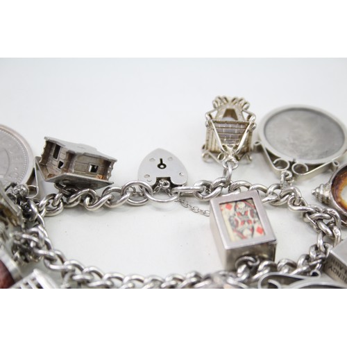 434 - Silver charm bracelet including articulated fish charm (115g)