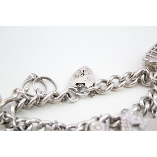 440 - Silver charm bracelet including wedding charms (95g)