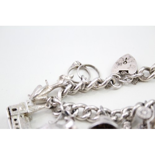 440 - Silver charm bracelet including wedding charms (95g)