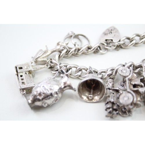 440 - Silver charm bracelet including wedding charms (95g)