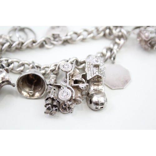 440 - Silver charm bracelet including wedding charms (95g)