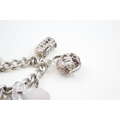 440 - Silver charm bracelet including wedding charms (95g)