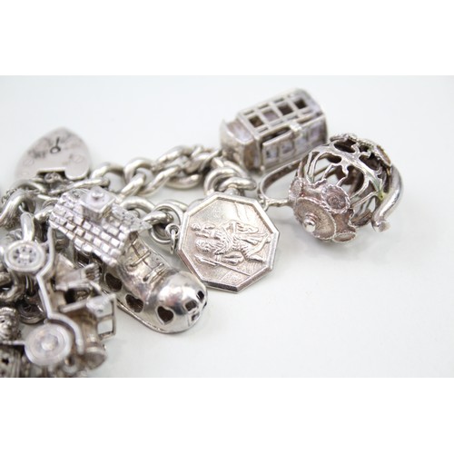 440 - Silver charm bracelet including wedding charms (95g)