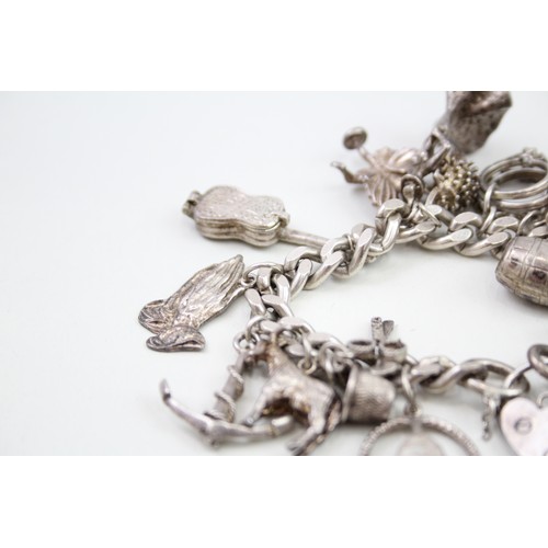 449 - Silver charm bracelet including dancer charms (88g)