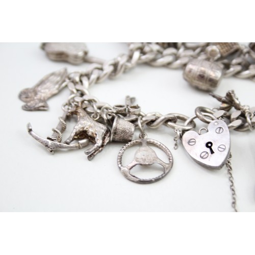 449 - Silver charm bracelet including dancer charms (88g)