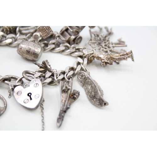 449 - Silver charm bracelet including dancer charms (88g)