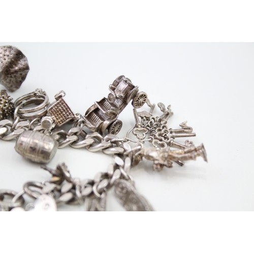 449 - Silver charm bracelet including dancer charms (88g)