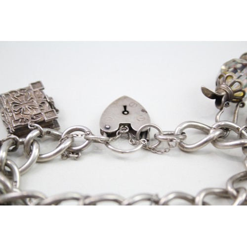 450 - Silver charm bracelet including antique charms (96g)