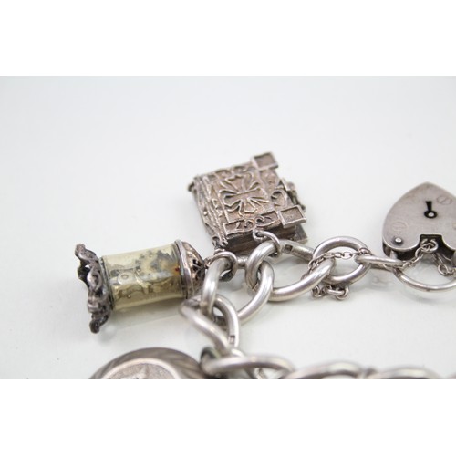 450 - Silver charm bracelet including antique charms (96g)