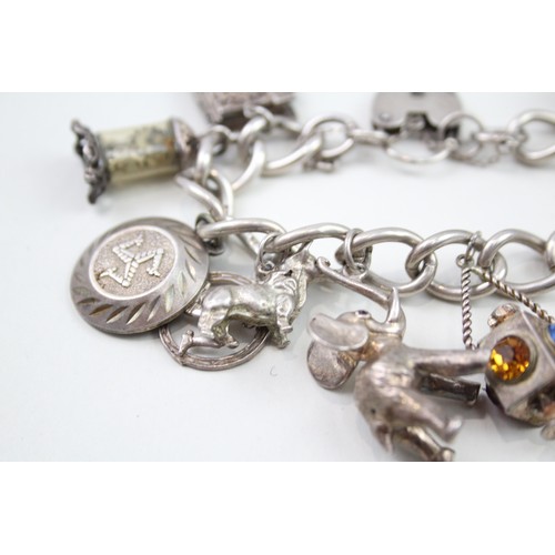 450 - Silver charm bracelet including antique charms (96g)