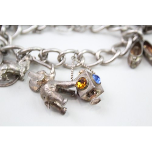 450 - Silver charm bracelet including antique charms (96g)