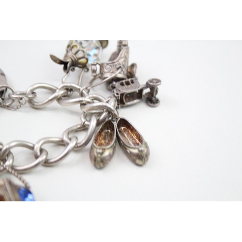 450 - Silver charm bracelet including antique charms (96g)