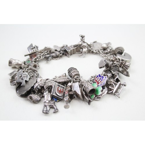 456 - Silver charm bracelet including souvenir charms (98g)