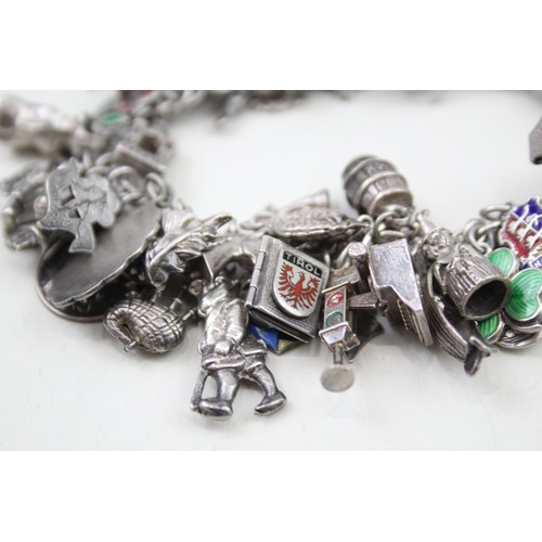 456 - Silver charm bracelet including souvenir charms (98g)