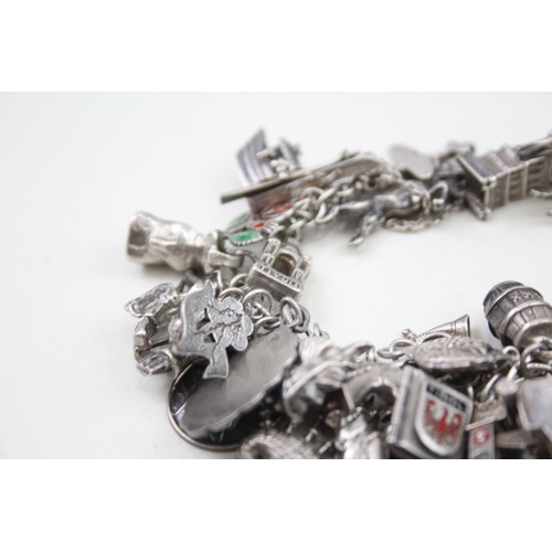 456 - Silver charm bracelet including souvenir charms (98g)