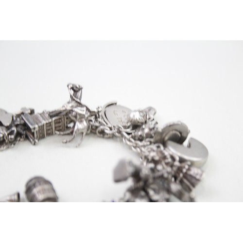 456 - Silver charm bracelet including souvenir charms (98g)