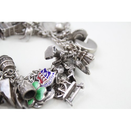 456 - Silver charm bracelet including souvenir charms (98g)