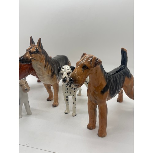 81 - 4 Royal Doulton dog figures includes Dalmatian, German Sheppard etc