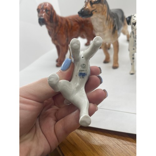 81 - 4 Royal Doulton dog figures includes Dalmatian, German Sheppard etc