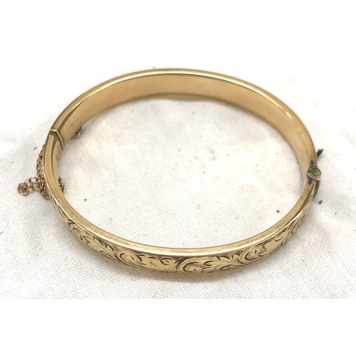 473 - 9ct gold metal core bangle and a silver stone set bangle