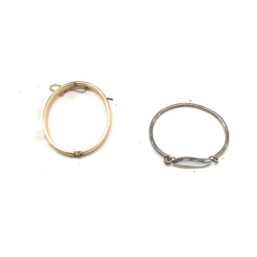 473 - 9ct gold metal core bangle and a silver stone set bangle