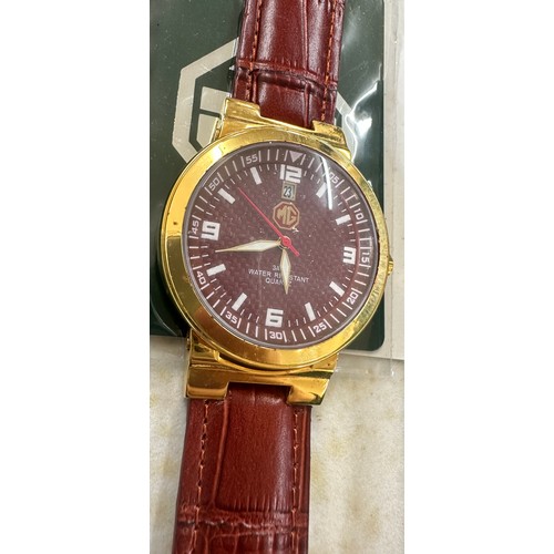 568 - Boxed MG gents wristwatch, MG Staff exhibition badge, MG Morris table lighter (engraved)