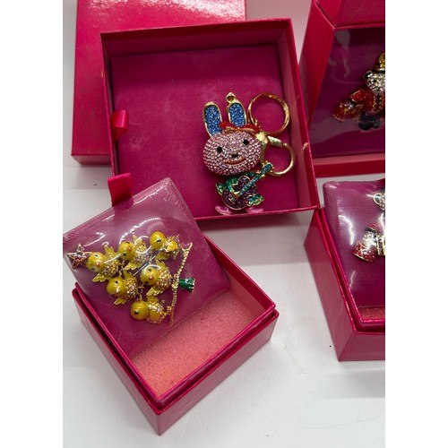 552 - Selection 5 boxed as new vintage Butler and Wilson keyrings and brooches to include a bunny, teddy b... 