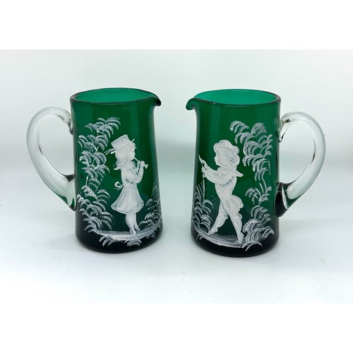 600 - Pair of Victorian Mary Gregory green glass jugs, very good overall condition, approximate height 5 i... 