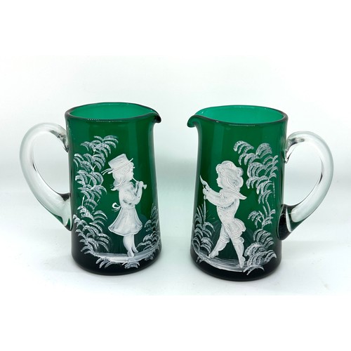 600 - Pair of Victorian Mary Gregory green glass jugs, very good overall condition, approximate height 5 i... 