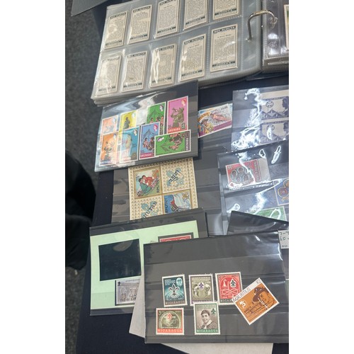 129 - Selection of vintage cigarette cards and stamps