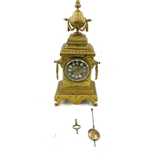 128 - Vintage brass 2 key hole mantel clock with key and pendulum, approximate measurements Height 16 inch... 