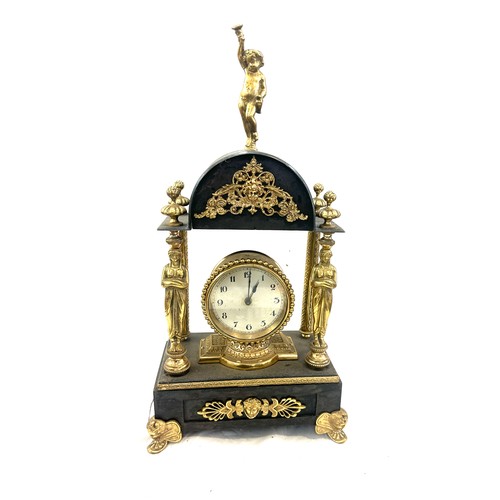 86 - Vintage brass and metal clock with key measures approx 18 inches tall by 9 inches wide