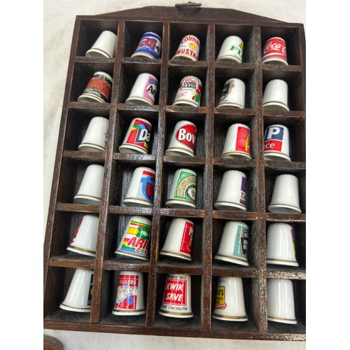 43 - Selection of over a 100 advertising  thimbles in wooden cases