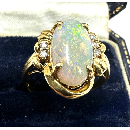 98 - 18ct gold large opal & diamond ring opal measures approx 16mm by 8mm with 3 diamons each side weight... 