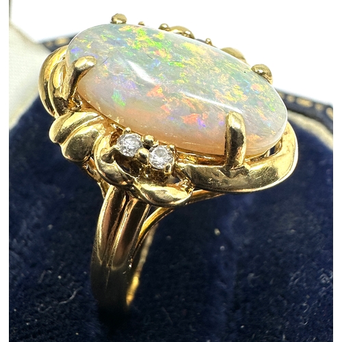 98 - 18ct gold large opal & diamond ring opal measures approx 16mm by 8mm with 3 diamons each side weight... 