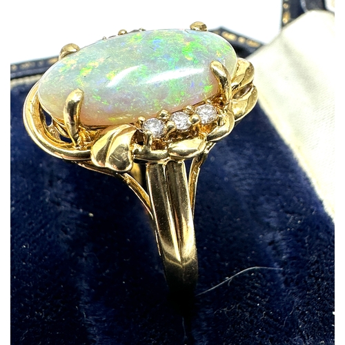 98 - 18ct gold large opal & diamond ring opal measures approx 16mm by 8mm with 3 diamons each side weight... 