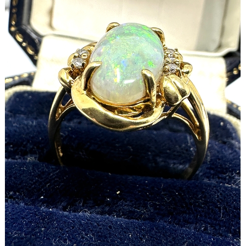 98 - 18ct gold large opal & diamond ring opal measures approx 16mm by 8mm with 3 diamons each side weight... 