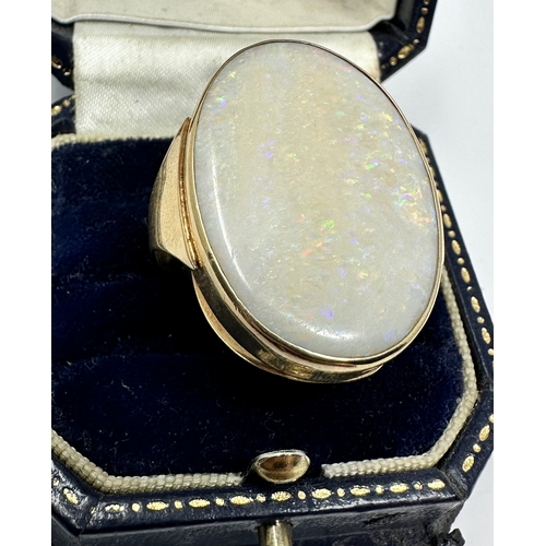 99 - 9ct gold ring set with very large opal that measures approx 31mm by 22mm weight of ring 10.5g