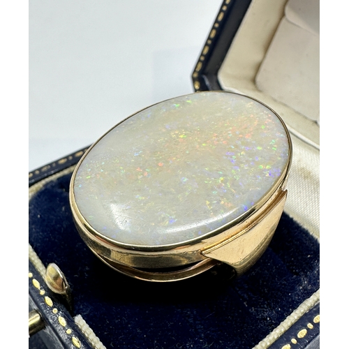 99 - 9ct gold ring set with very large opal that measures approx 31mm by 22mm weight of ring 10.5g