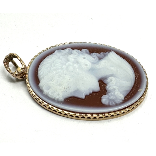 121 - 9ct gold framed hard stone cameo pendant measures approx 4cm drop by 2.3cm wide weight 5.5g