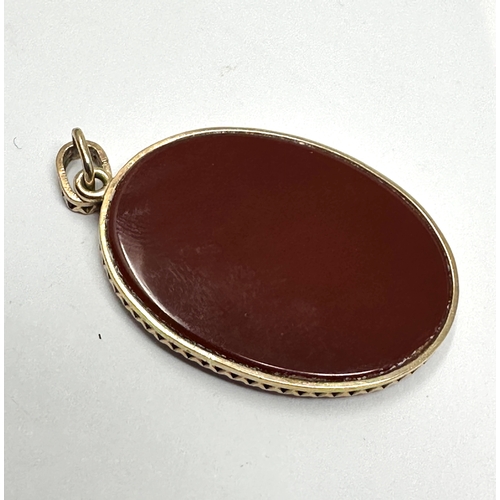 121 - 9ct gold framed hard stone cameo pendant measures approx 4cm drop by 2.3cm wide weight 5.5g