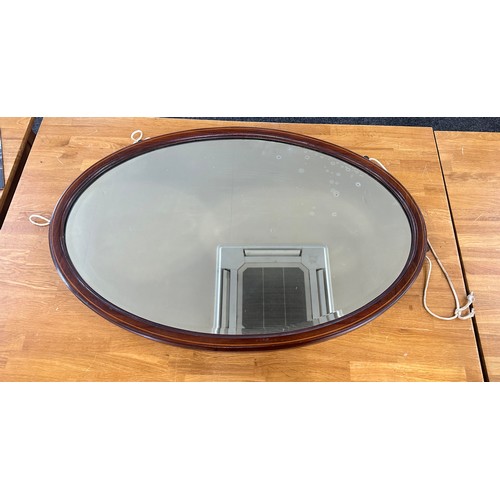 353 - Mahogany inlaid oval mirror measures approximately 35 inches by 23 inches