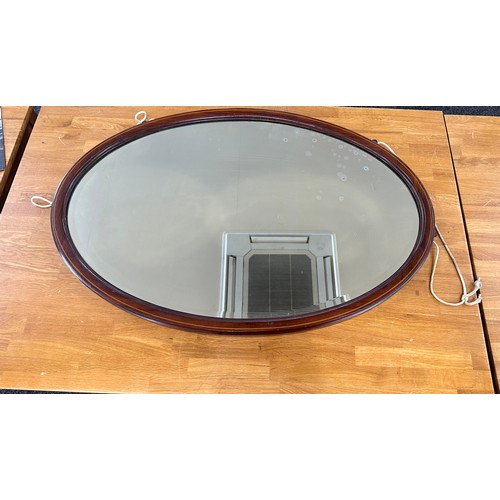 353 - Mahogany inlaid oval mirror measures approximately 35 inches by 23 inches