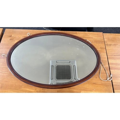 353 - Mahogany inlaid oval mirror measures approximately 35 inches by 23 inches