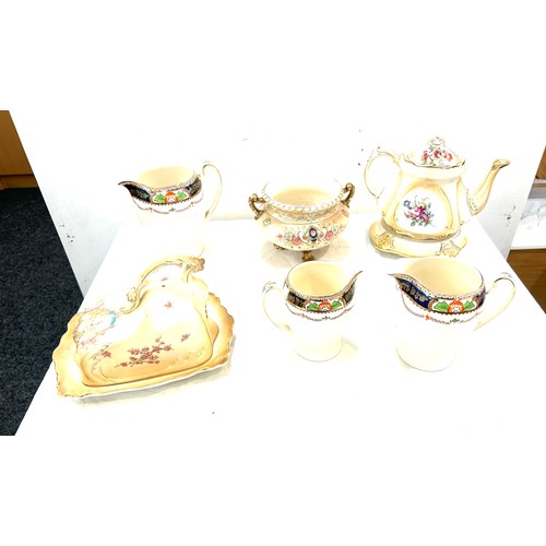 345 - Selection of assorted pottery includes cheese dish, candle stick etc