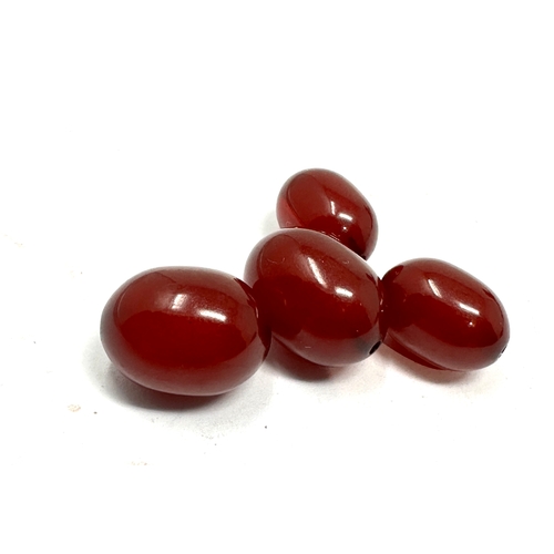 334 - 2 pairs of matching size cherry bakelite beads both pairs have internal streaking would make great e... 