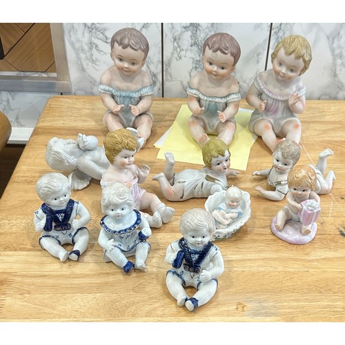 376 - Large selection of assorted Baby figures includes Piano babies etc